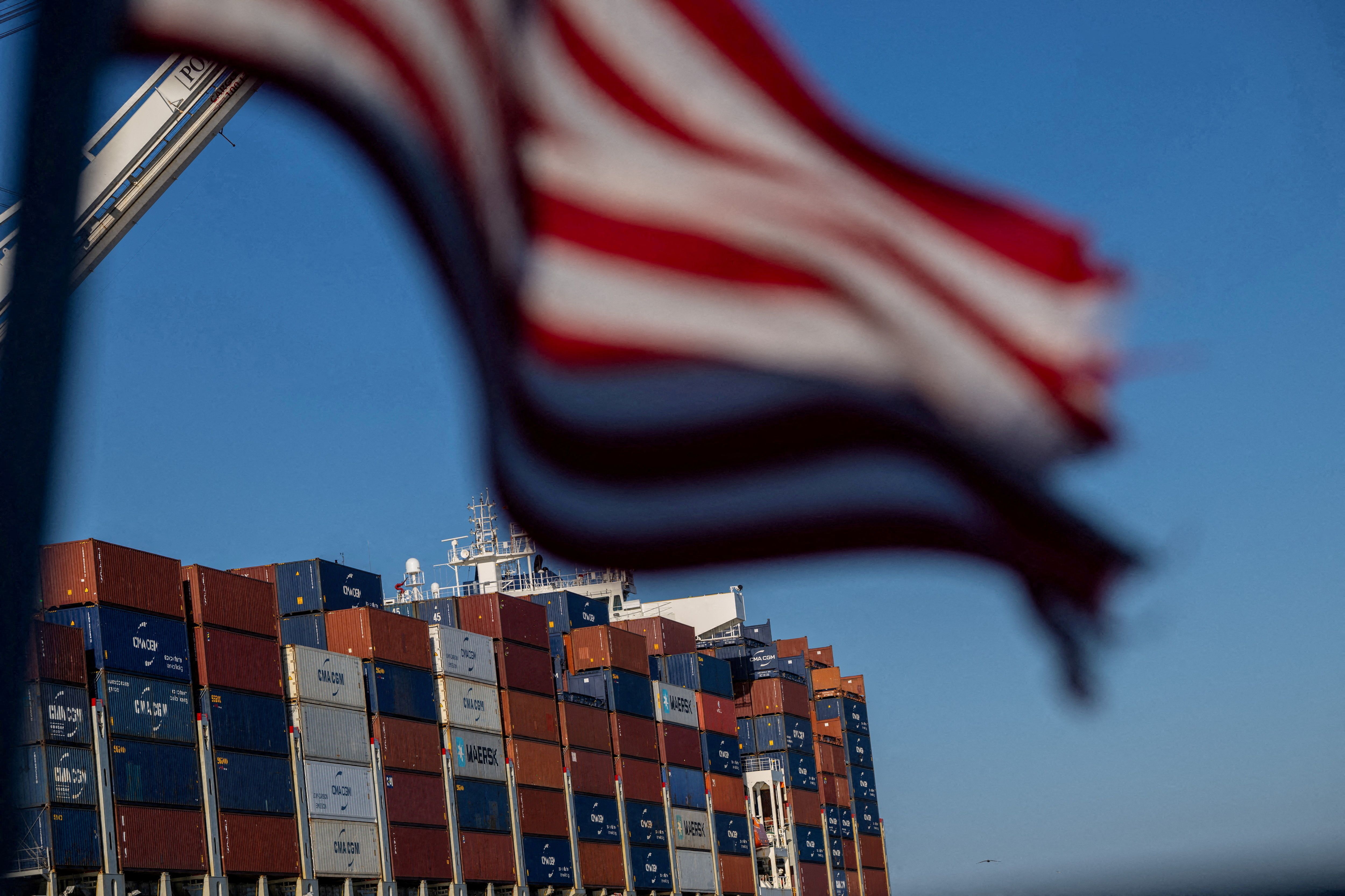 A cargo ship full of shipping containers is seen at the port of Oakland
