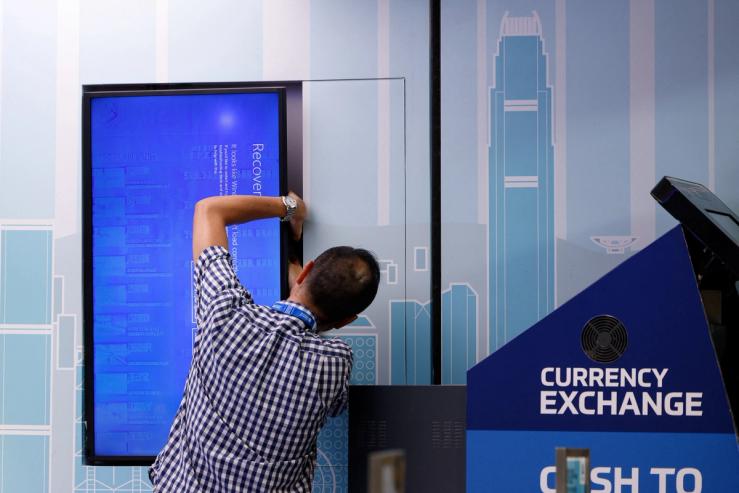 Screen showing an error is seen at a currency exchange store at Hong Kong International Airport amid system outages disrupting the operations, in Hong Kong, China, July 19, 2024. REUTERS/Tyrone Siu