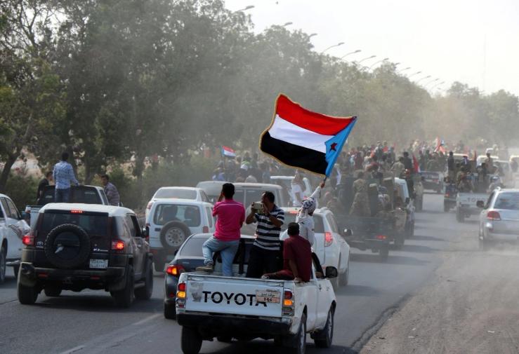 People wave the flag of the former South Yemen