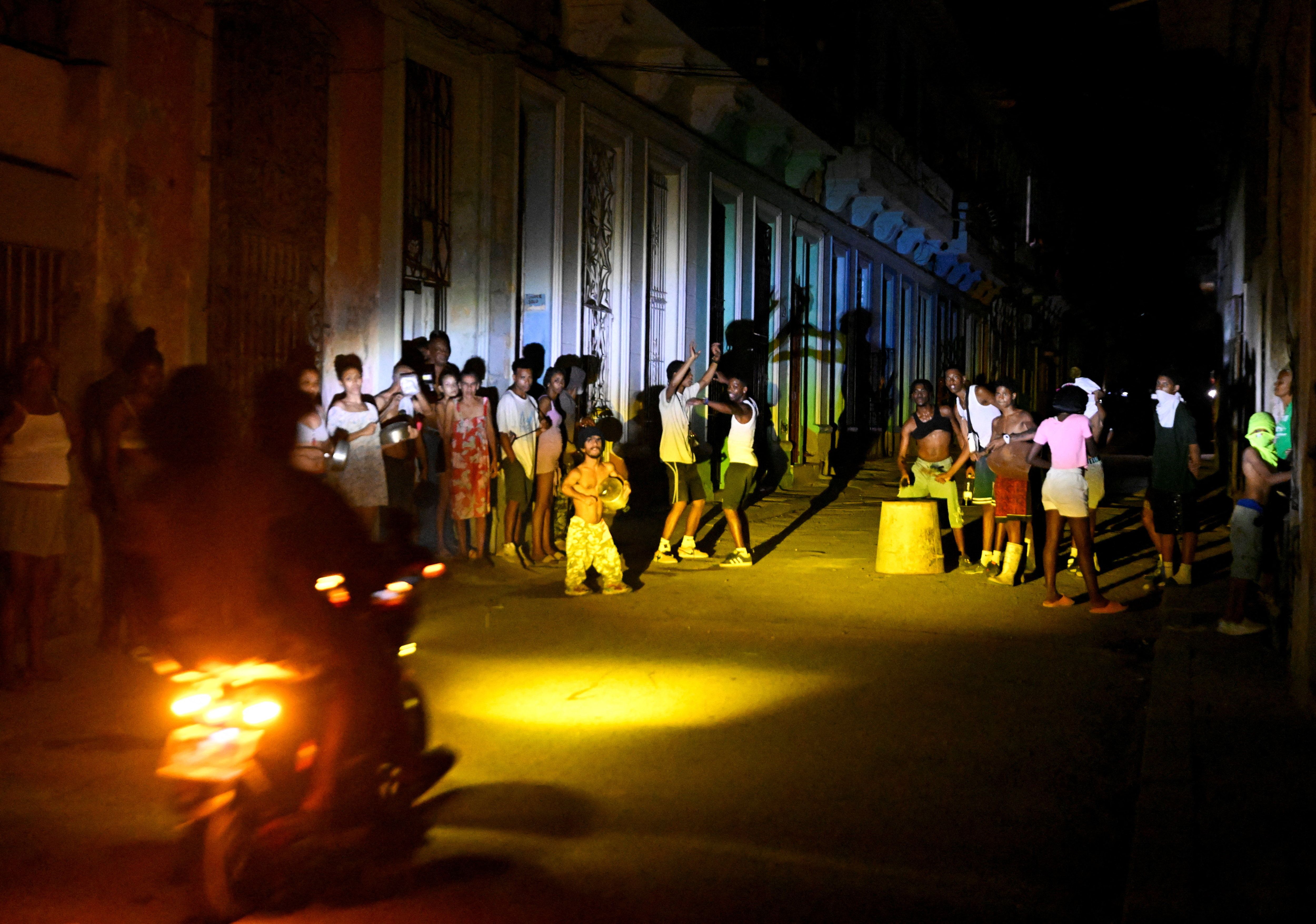 People gather on a street during a blackout as Cuba’s national electric grid collapsed.