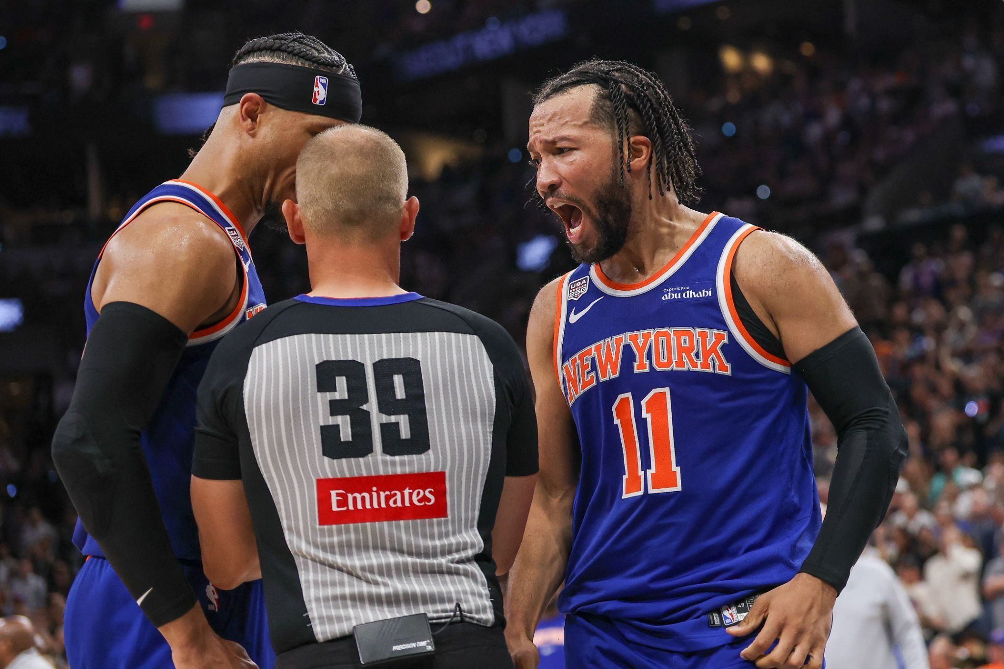 San Antonio, Texas, USA; New York Knicks guard Jalen Brunson (11) yells at referee Tyler Ford (39) during the third quarter during game five of the 2026 NBA Finals at Frost Bank Center.