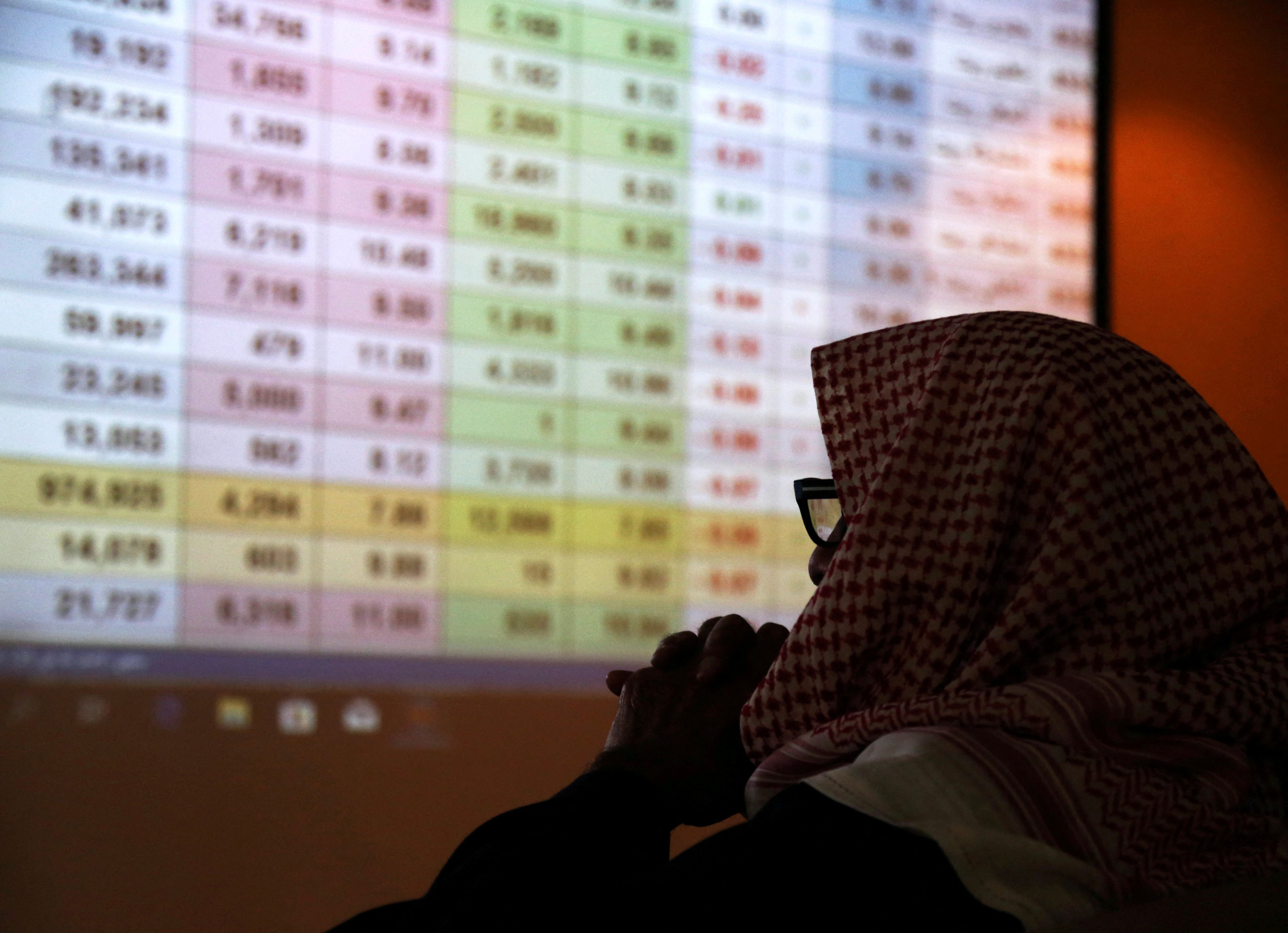 A Saudi trader monitors stocks at the Saudi stock market in Riyadh.