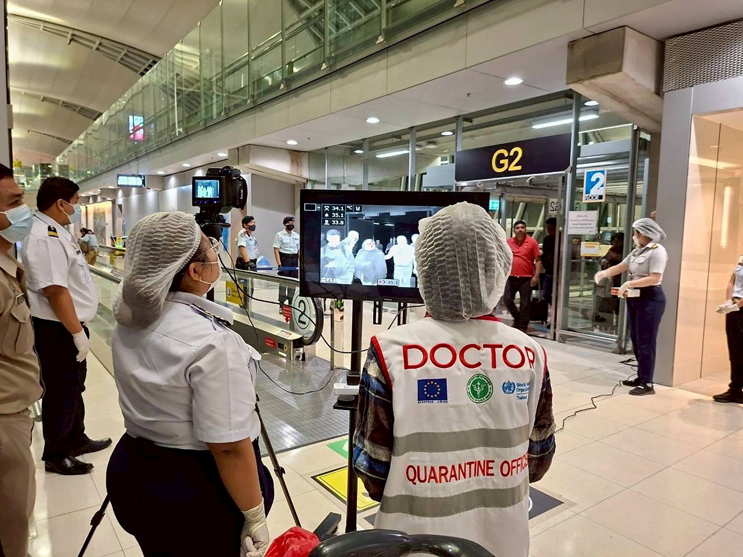 Airport health authorities wearing protective masks monitor passengers from international flights arriving at Suvarnabhumi International Airport in Bangkok, Thailand, January 25, 2026