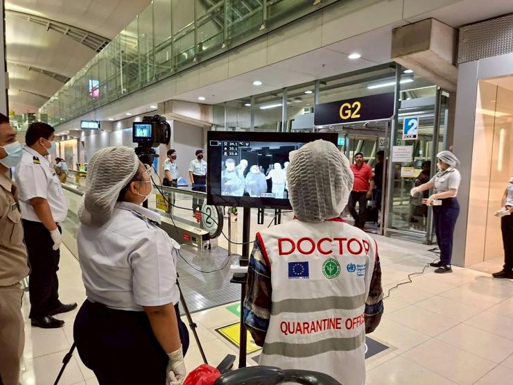 Airport health authorities wearing protective masks monitor passengers from international flights arriving at Suvarnabhumi International Airport in Bangkok, Thailand, January 25, 2026