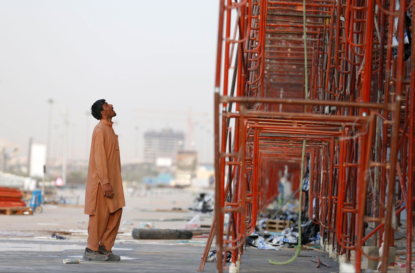 An Indian laborer looks at the construction site of a building in Riyadh. 