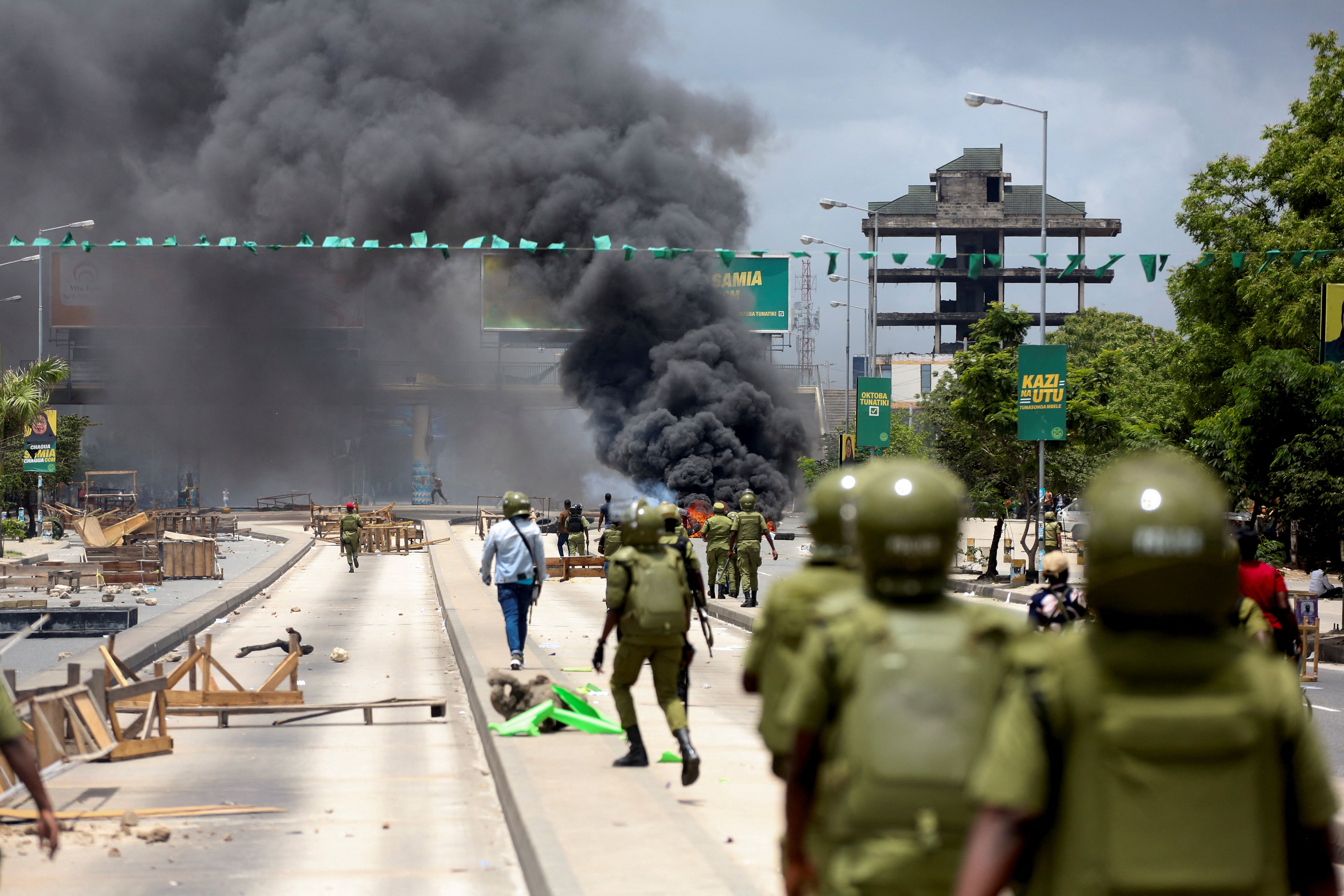 Tanzanian riot police disperse demonstrators during violent protests.