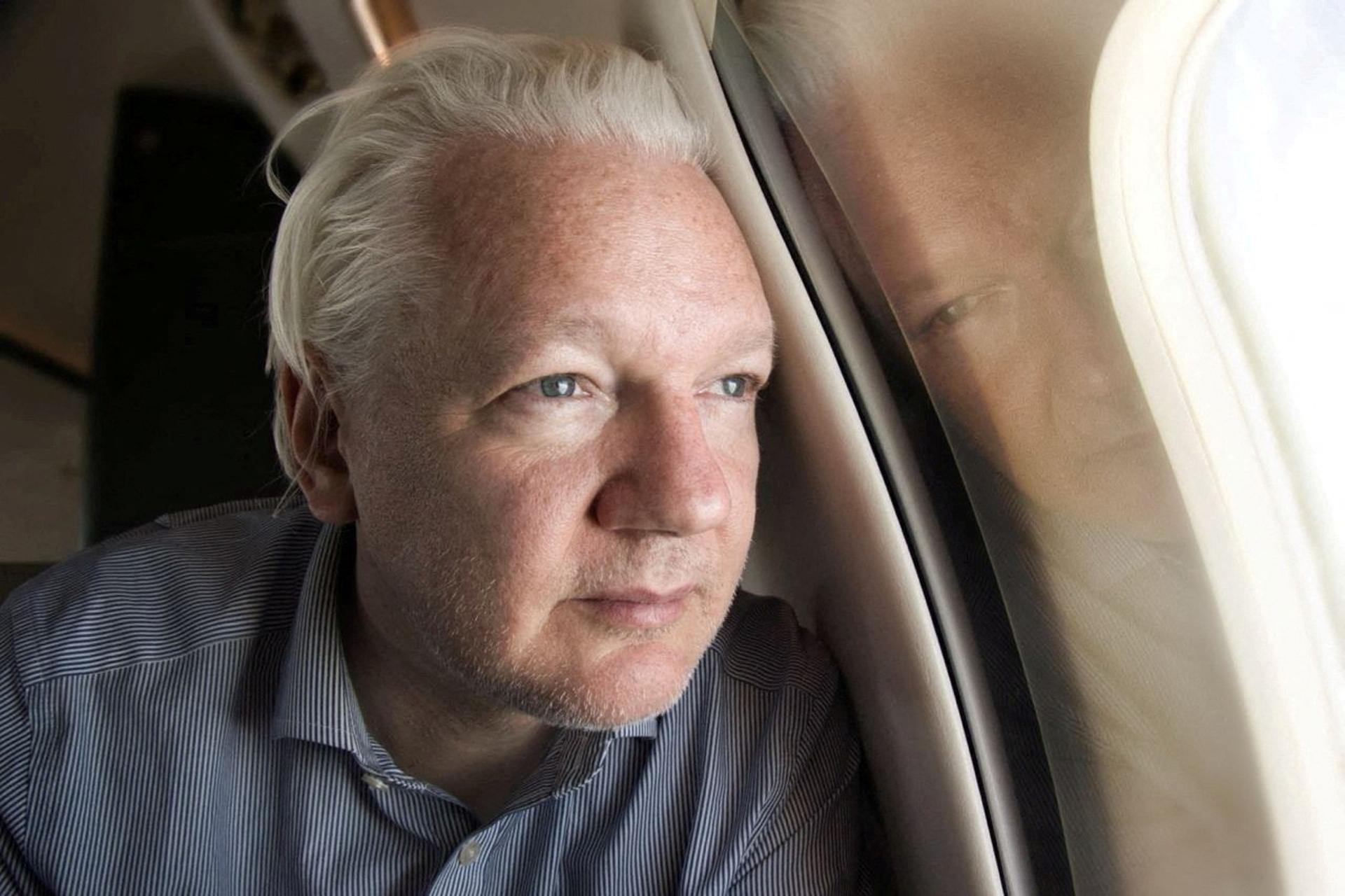 WikiLeaks founder Julian Assange looks out a plane window as he approaches Bangkok airport for layover, according to the post by Wikileaks on X, in this picture released to social media on June 25, 2024. Wikileaks via X/via REUTERS