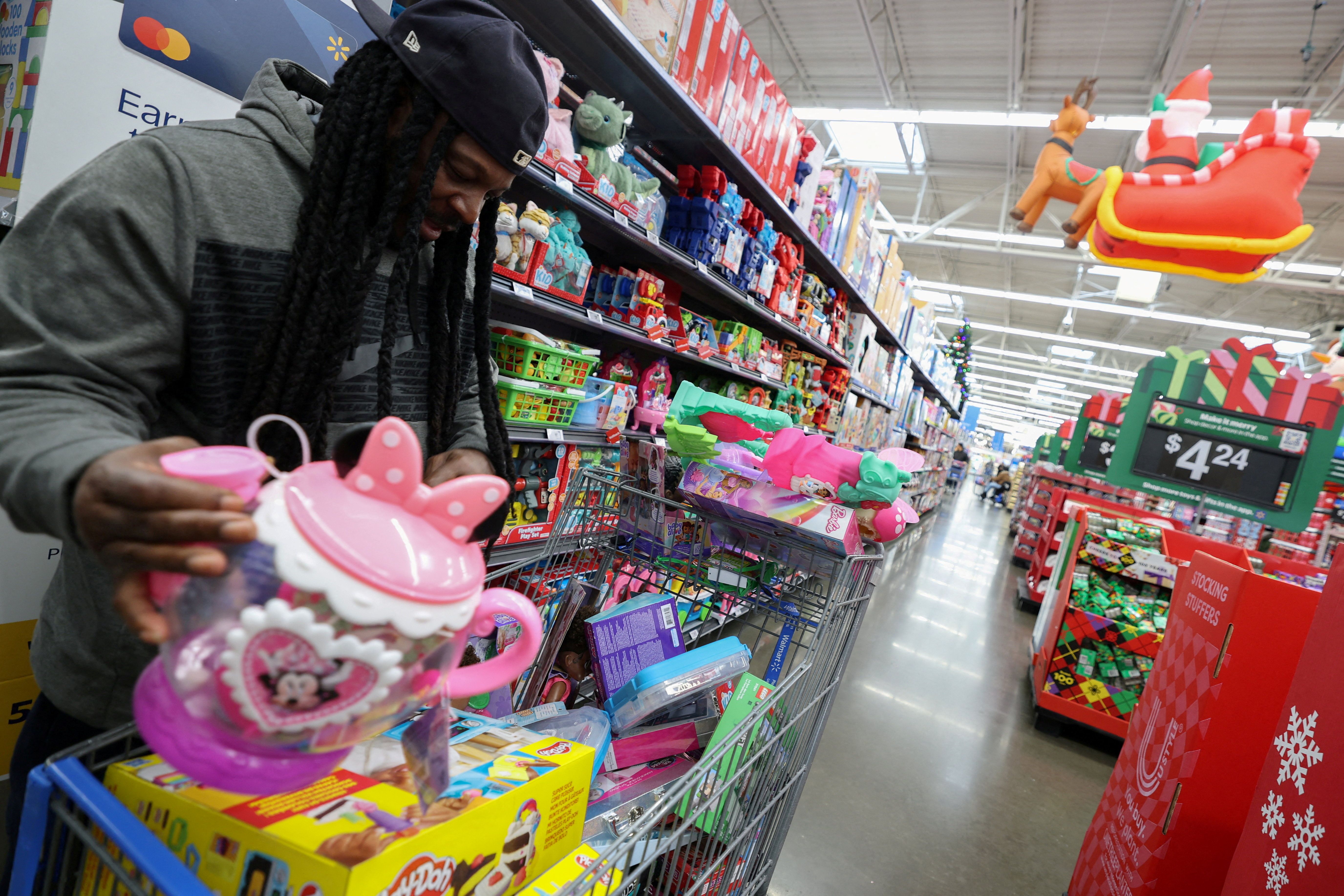 A customer shops for toys for holiday gifts at a Walmart