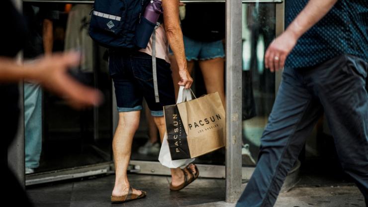 A person carries shopping bags in Manhattan in New York City.