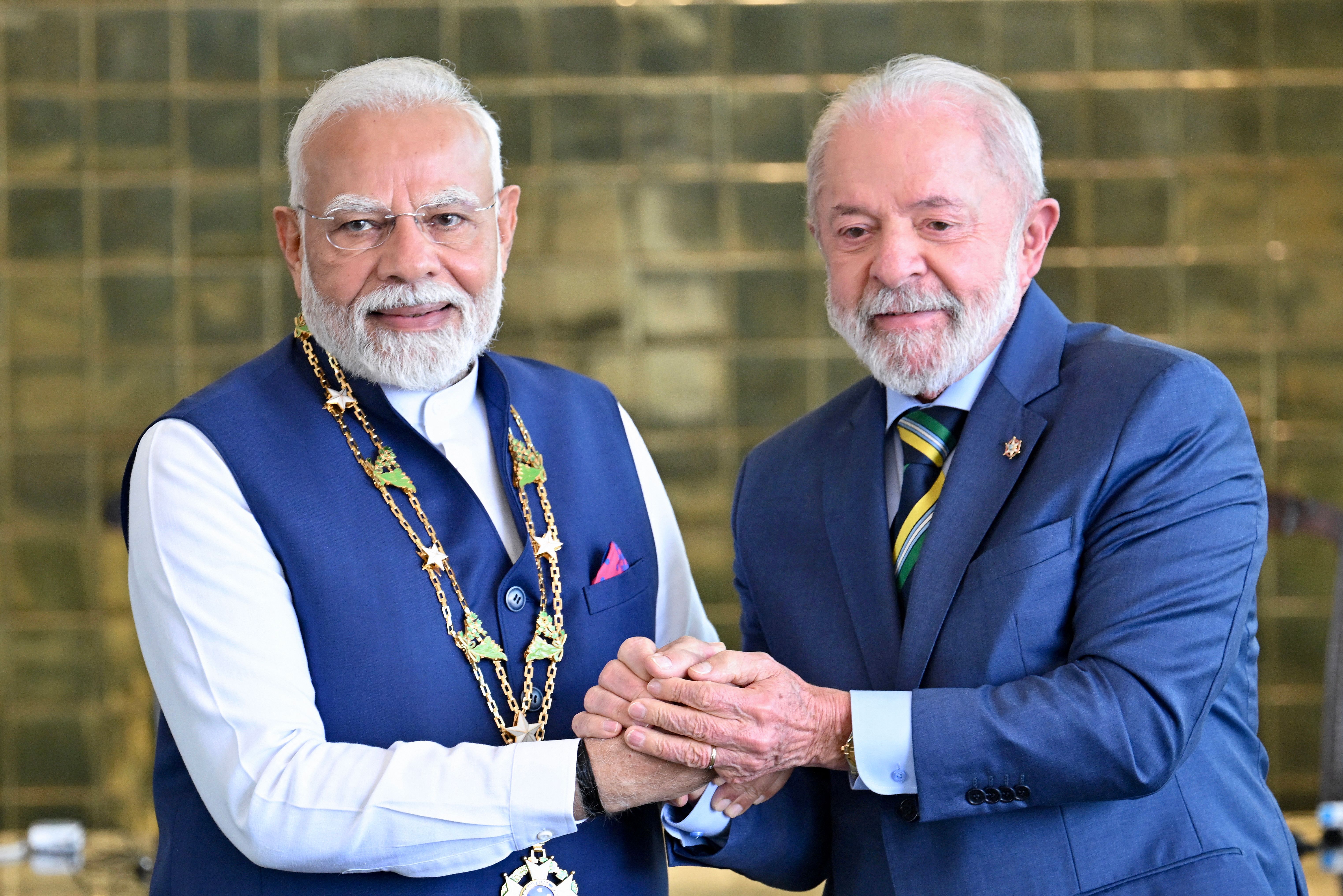 India’s Prime Minister Narendra Modi holds hands with Brazil’s President Luiz Inacio Lula da Silva.