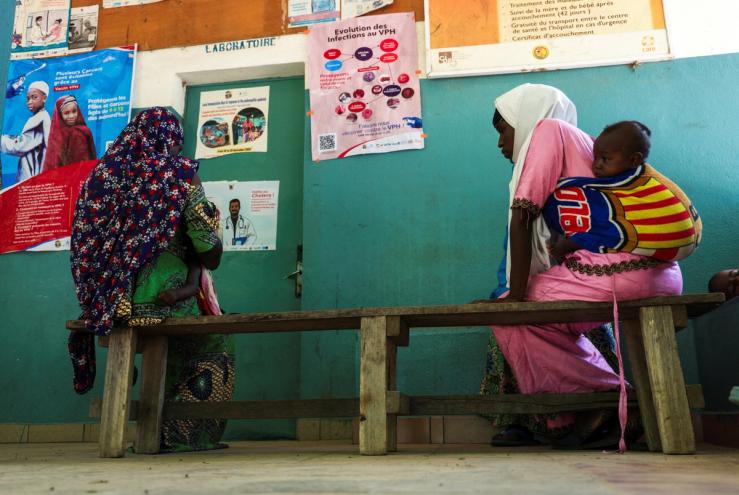 Women sit as they wait for medical consultation at a health center in Cameroon.