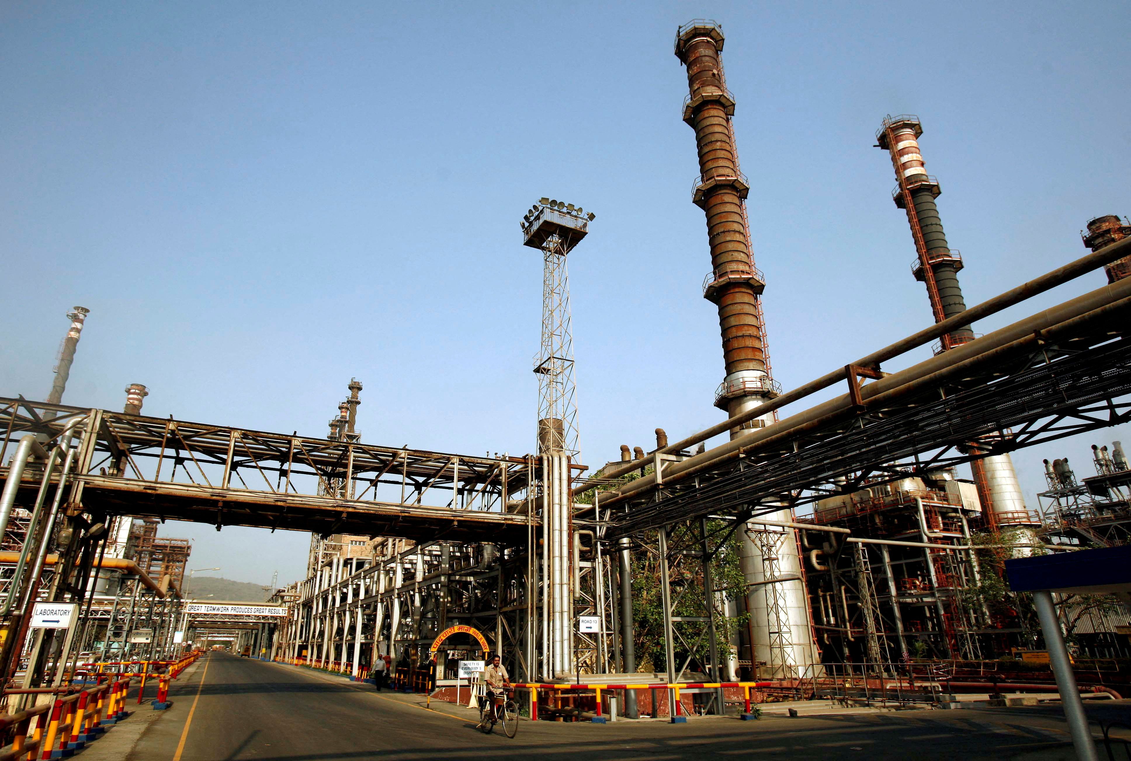  A worker rides a bicycle at the Bharat Petroleum Corporation Ltd. refinery.