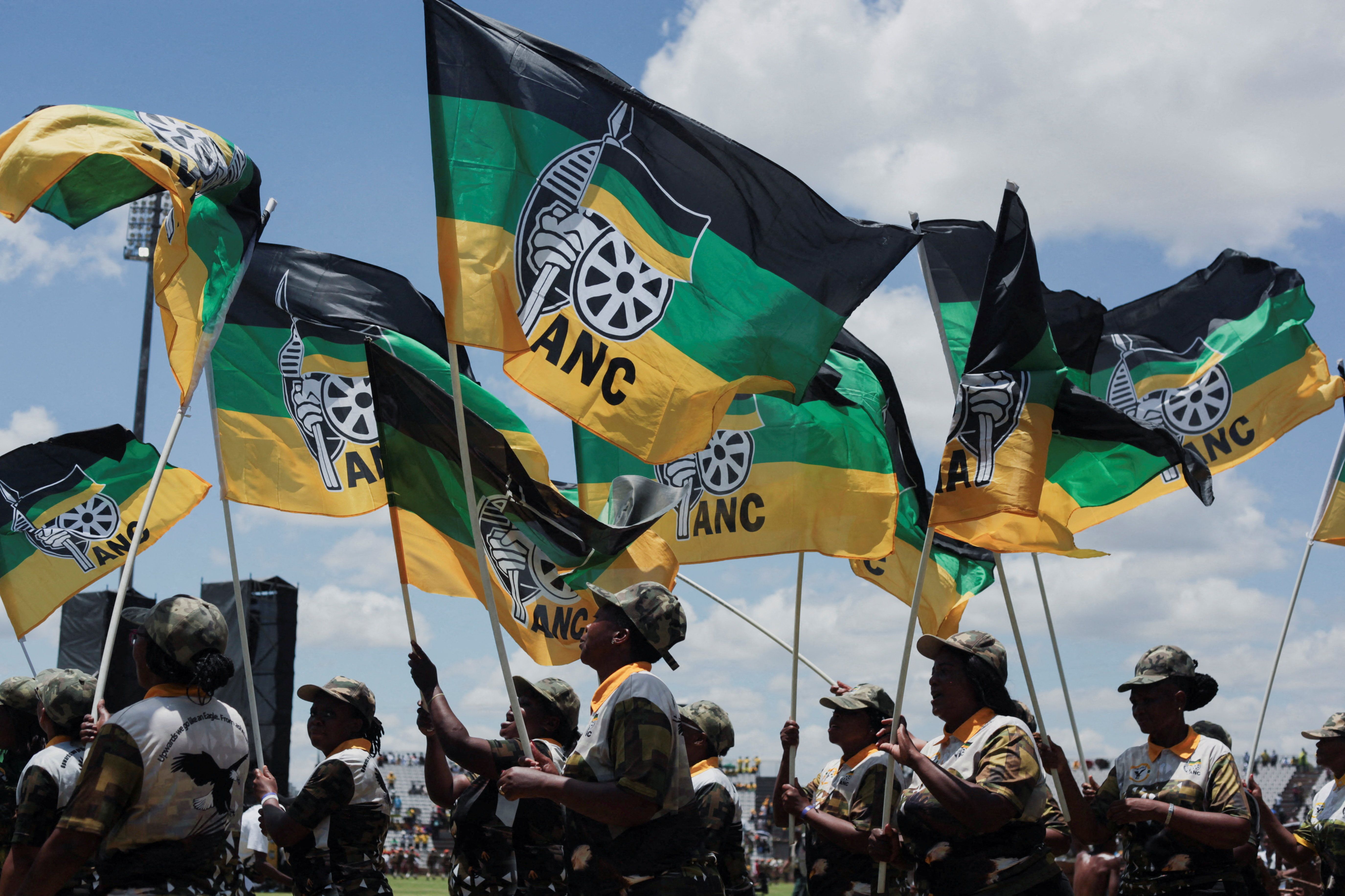 African National Congress supporters hold flags during the ANC’s anniversary celebration. 