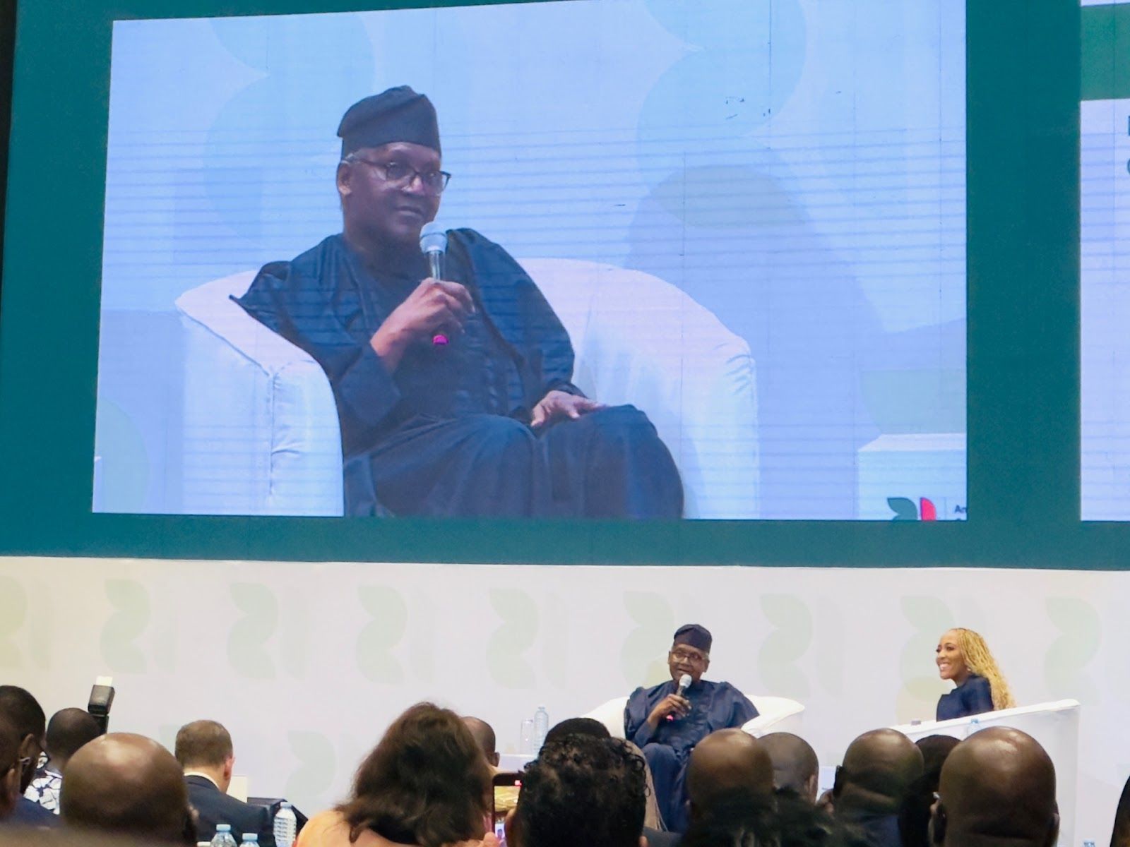 Aliko Dangote speaking on stage.