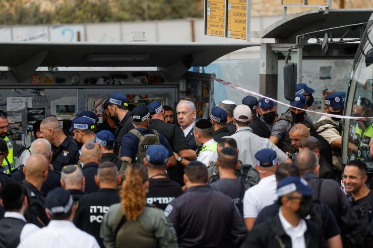 Israeli Prime Minister Benjamin Netanyahu looks on at the scene where a suspected shooting attack took place at the outskirts of Jerusalem.