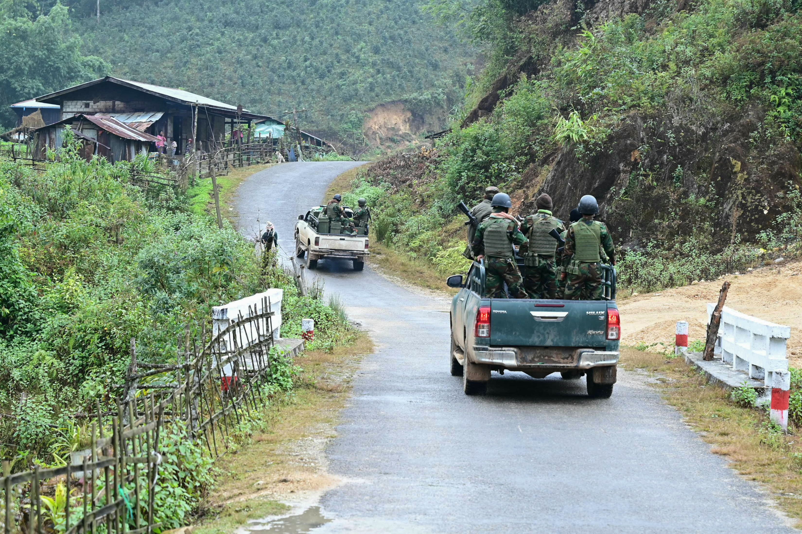 This photo taken on December 13, 2023 shows members of ethnic minority armed group Ta’ang National Liberation Army (TNLA) heading to the front line amid clashes with Myanmar’s military near Namhsan Township in Myanmar’s northern Shan State. Nestled in the hills of northern Shan state, the town of Namhsan is the latest to fall to Ta’ang National Liberation Army (TNLA) fighters since they launched a surprise offensive launched against Myanmar’s junta in October. 