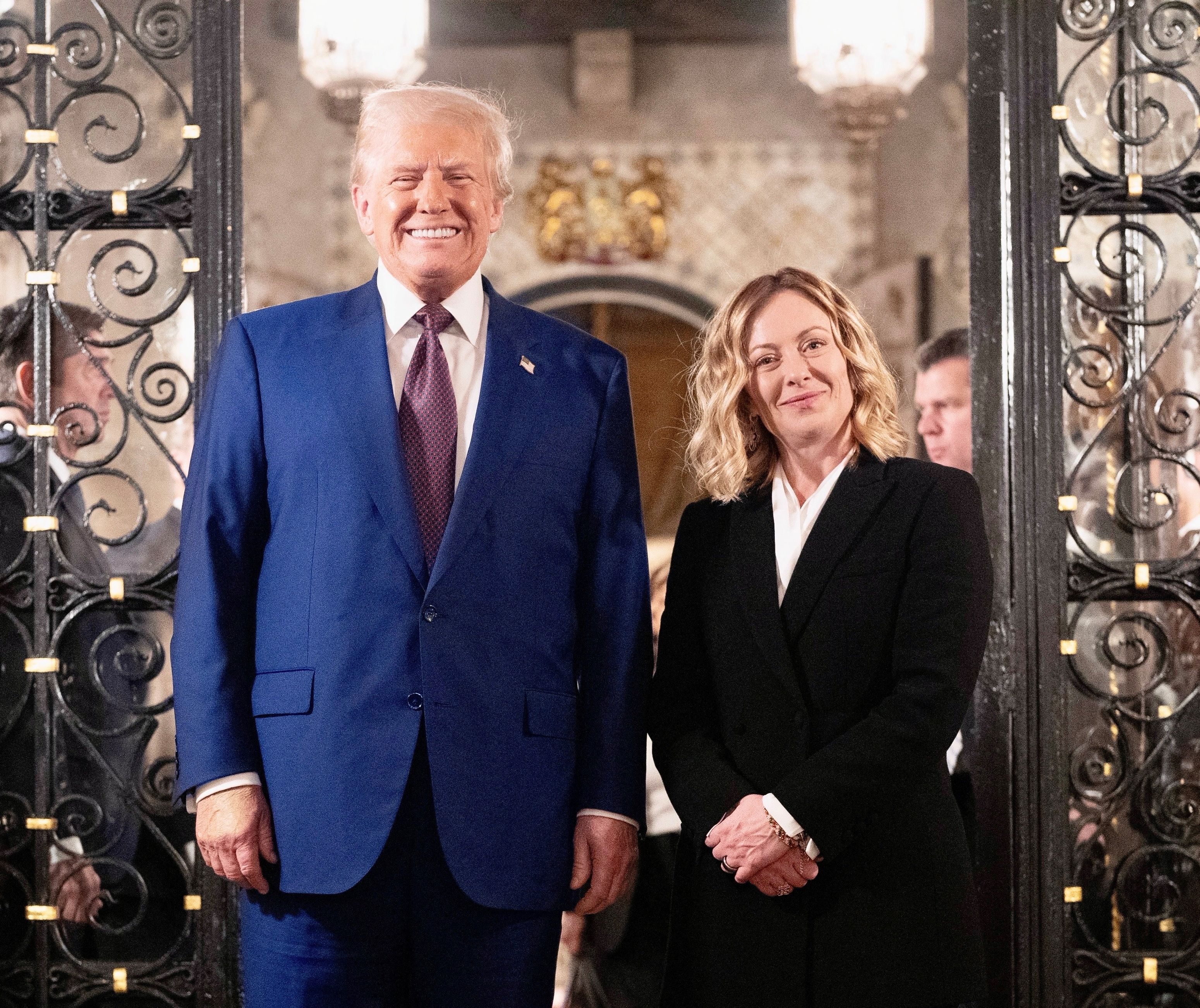 Donald Trump and Giorgia Meloni smile standing next to each other at Mar-a-Lago in Palm Beach, Florida