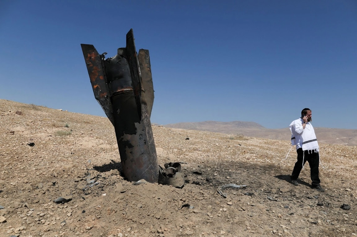 Part of a missile protrudes from the ground, following strikes from Iran, in the central Israeli-occupied West Bank.