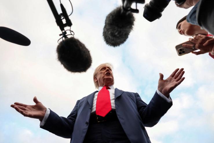 US President Donald Trump speaks to the media after arriving at Glasgow Prestwick Airport.
