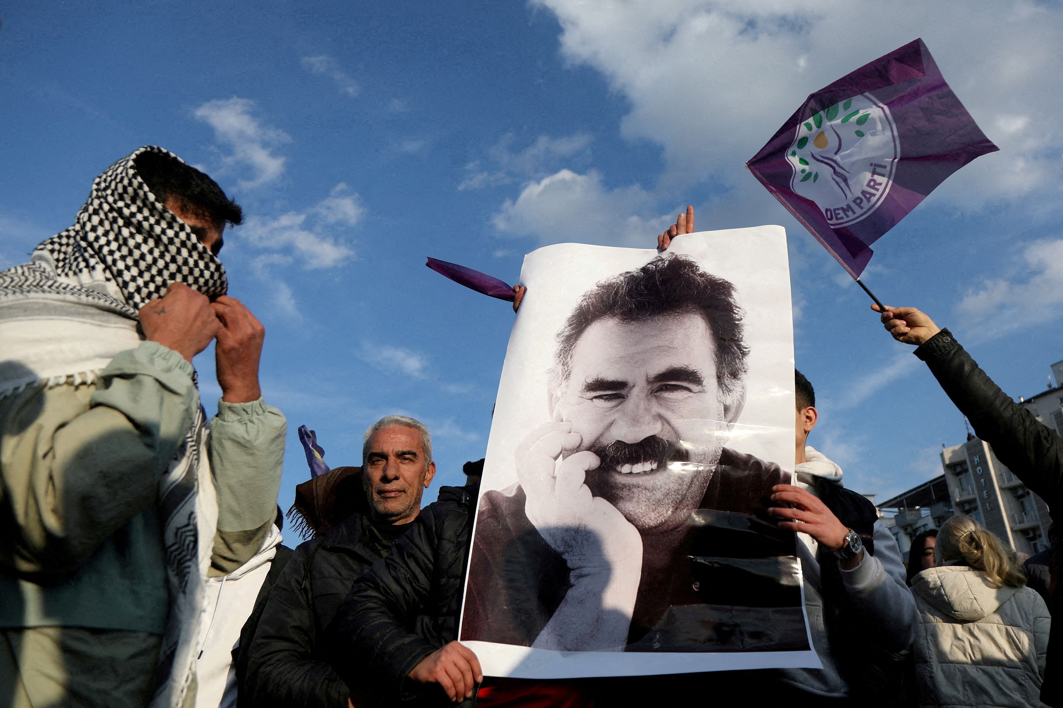 A demonstrator holds a picture of jailed Kurdish militant leader Abdullah Ocalan.