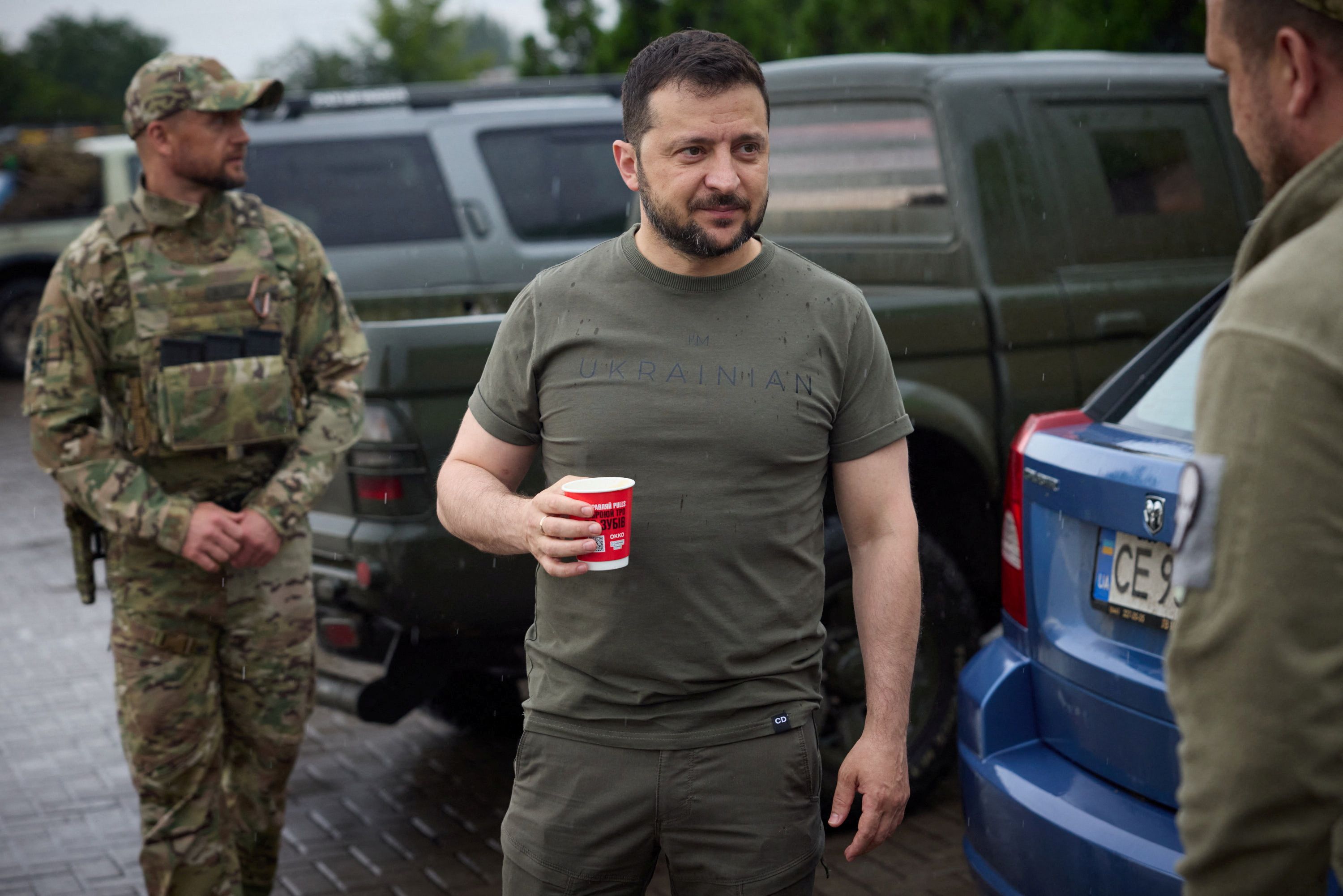 Ukraine’s President Volodymyr Zelenskiy drinks coffee at a petrol station after visiting positions near the front line.