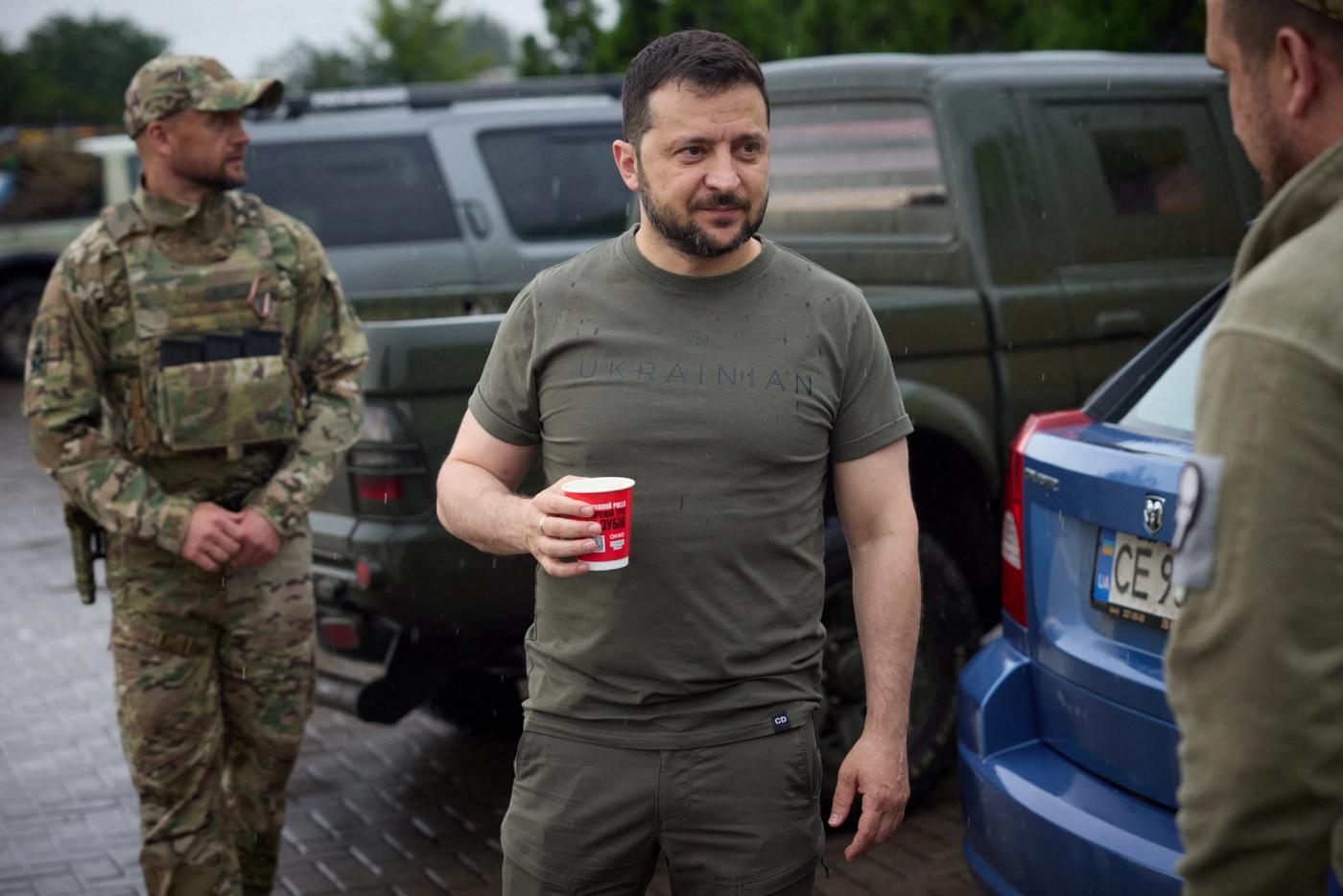 Ukraine's President Volodymyr Zelenskiy drinks coffee at a petrol station after visiting positions near the front line.