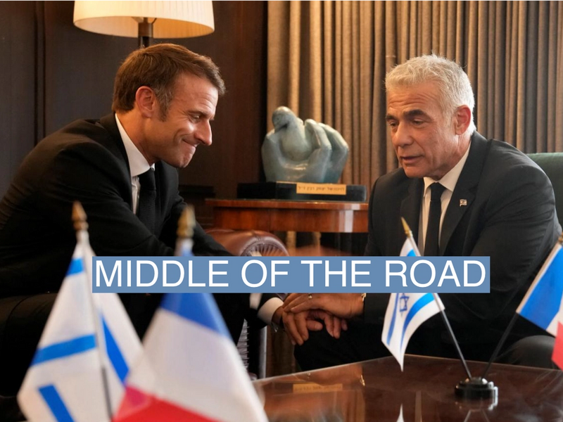 French President Emmanuel Macron, left, shakes hands with Israeli opposition leader Yair Lapid before their talks, amid the Israeli-Hamas conflict, in Jerusalem, October 24, 2023. Christophe Ena/Pool via REUTERS