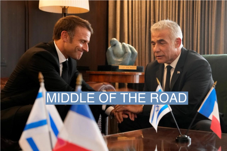 French President Emmanuel Macron, left, shakes hands with Israeli opposition leader Yair Lapid before their talks, amid the Israeli-Hamas conflict, in Jerusalem, October 24, 2023. Christophe Ena/Pool via REUTERS