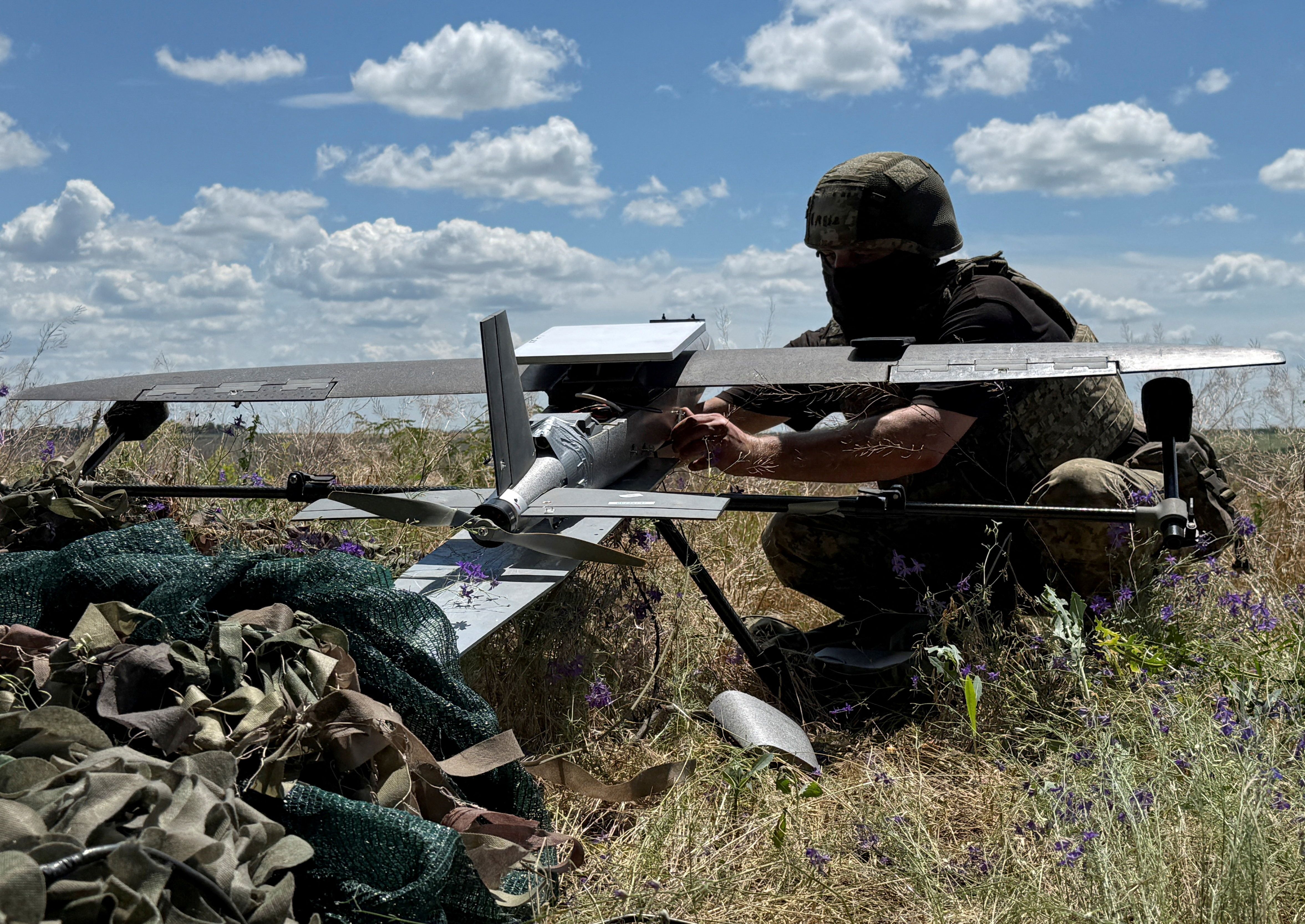 A serviceman of the 25th Separate Airborne Brigade of the Air Assault Forces of Ukraine prepares to launch a Hornet middle strike drone towards Russian troops
