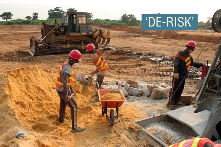 Labourers mix cement at the site of a new port to be built in the oil-producing Angolan exclave of Cabinda