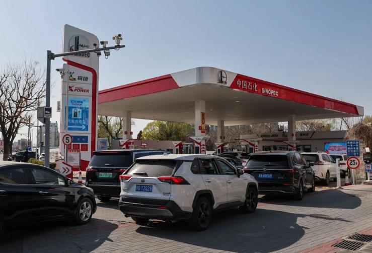 Drivers queue at a Sinopec gas station