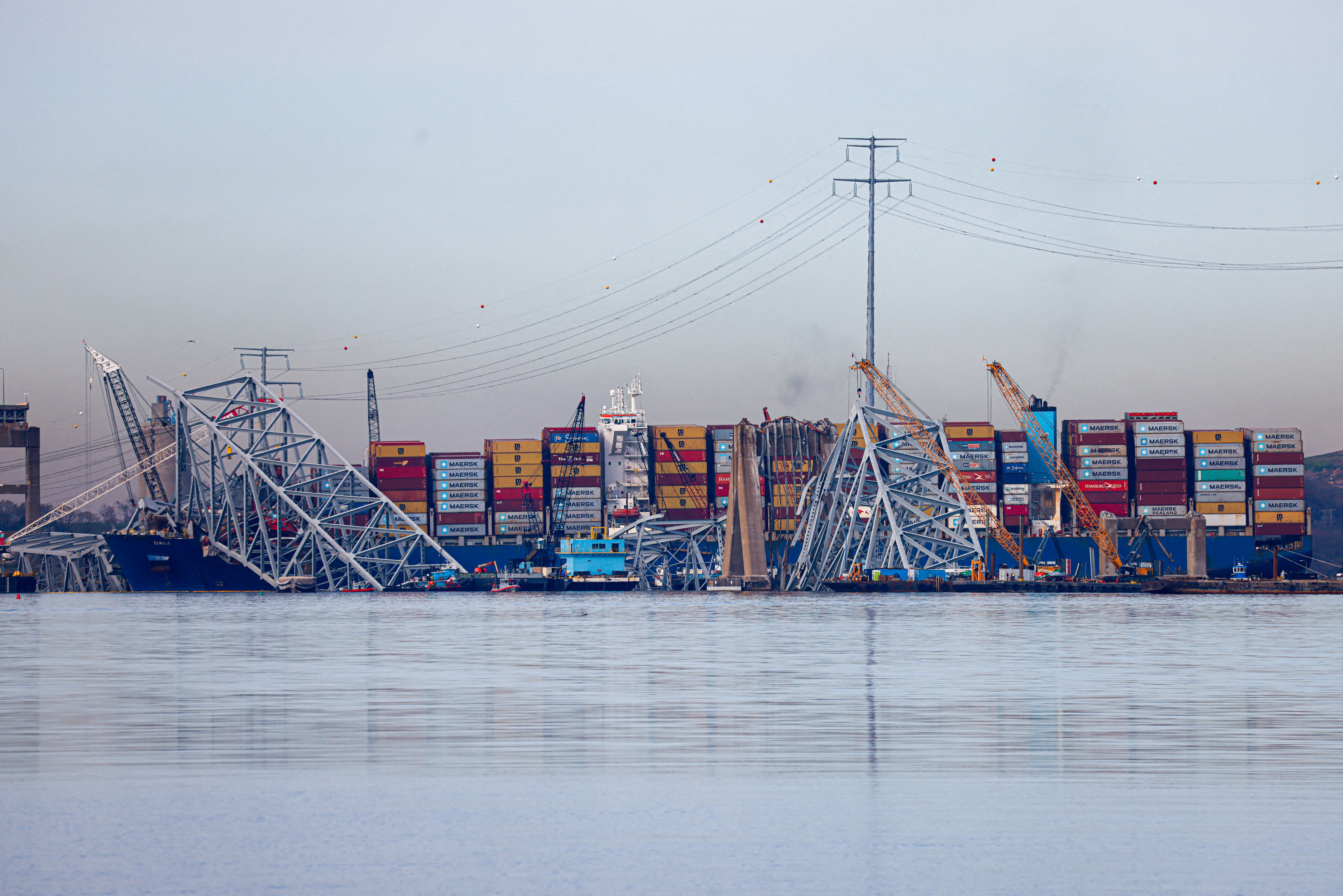 Wreckage of the collapsed Francis Scott Key Bridge lies atop the container ship Dali as salvage work continues in Baltimore on April 8, 2024. 