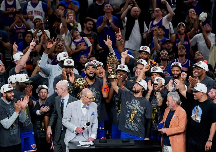 The New York Knicks celebrate with the Larry O’Brien Championship Trophy