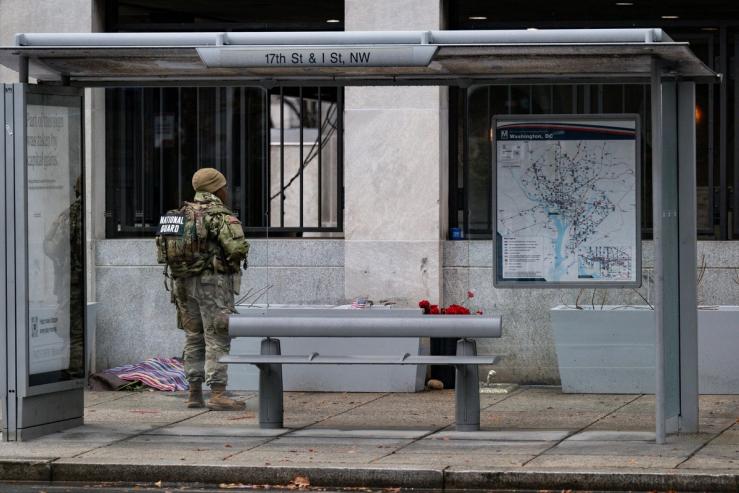 A National Guard troop patrols near the shooting site