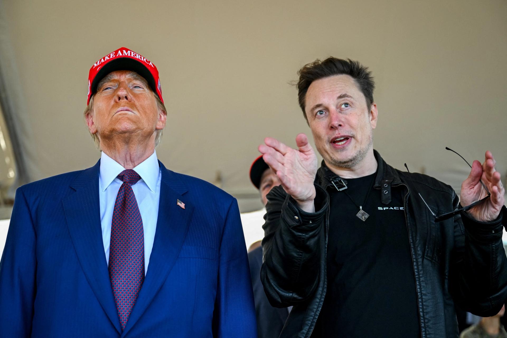 Elon Musk speaks with Donald Trump as they watch the launch of the sixth test flight of the SpaceX Starship rocket in Brownsville, Texas.