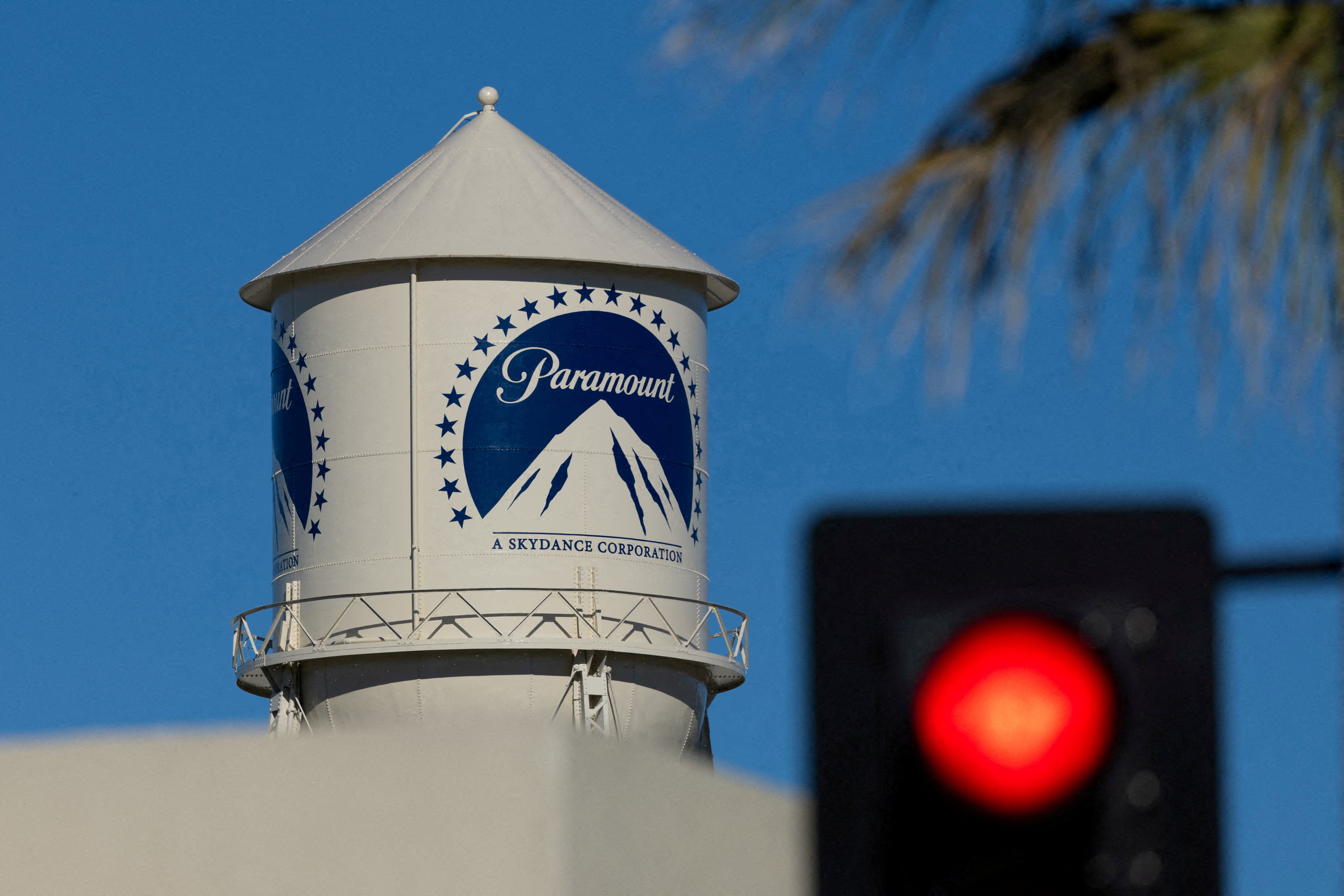 A city street stop sign is shown next to the Paramount water tower at the Paramount studio lot in Hollywood