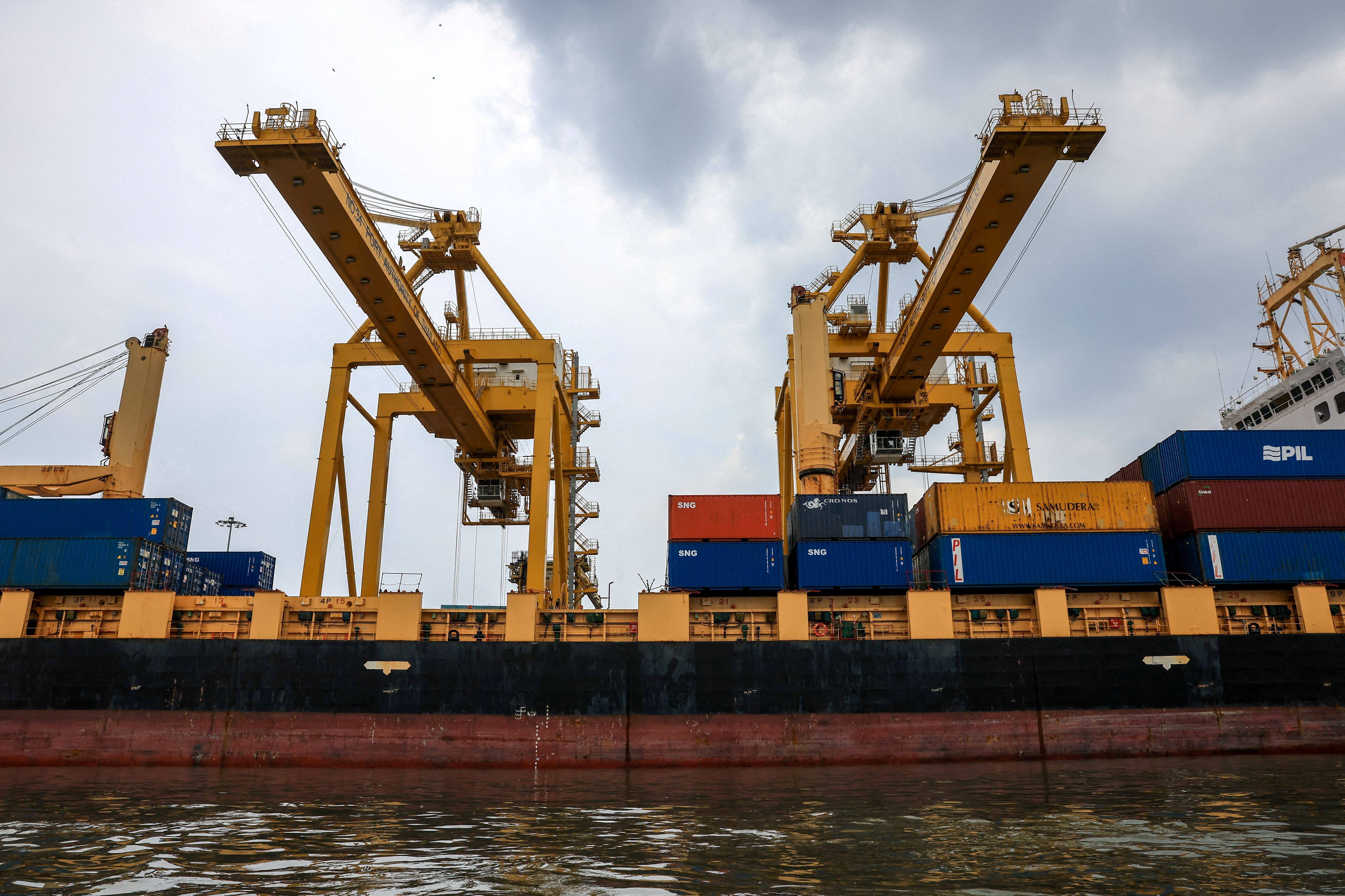 A cargo ship is loaded with containers while docked at the port of Bangkok, in Bangkok, Thailand.