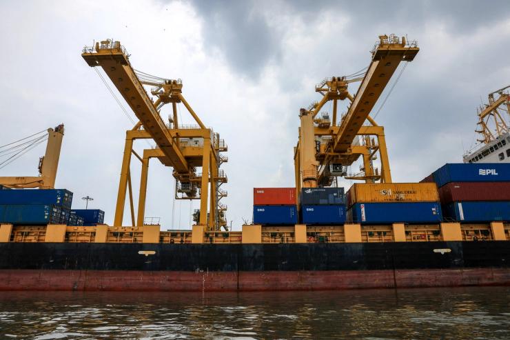 A cargo ship is loaded with containers while docked at the port of Bangkok, in Bangkok, Thailand.