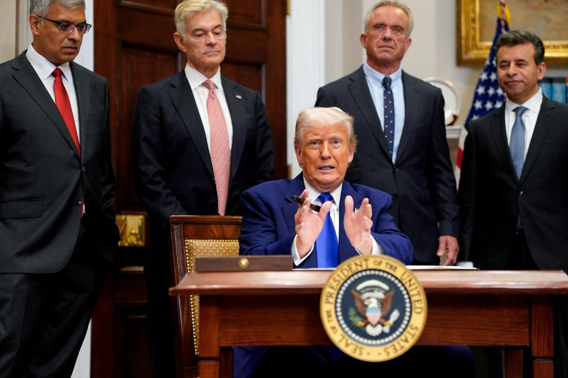 U.S. President Donald Trump gestures on the day he signs an executive order on prescription drug pricing, next to U.S. Health and Human Services (HHS) Secretary Robert F. Kennedy, Jr., during a press conference in the Roosevelt Room at the White House in Washington, D.C., U.S., May 12, 2025.