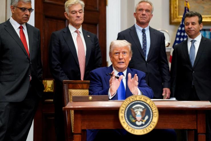 U.S. President Donald Trump gestures on the day he signs an executive order on prescription drug pricing, next to U.S. Health and Human Services (HHS) Secretary Robert F. Kennedy, Jr., during a press conference in the Roosevelt Room at the White House in Washington, D.C., U.S., May 12, 2025.