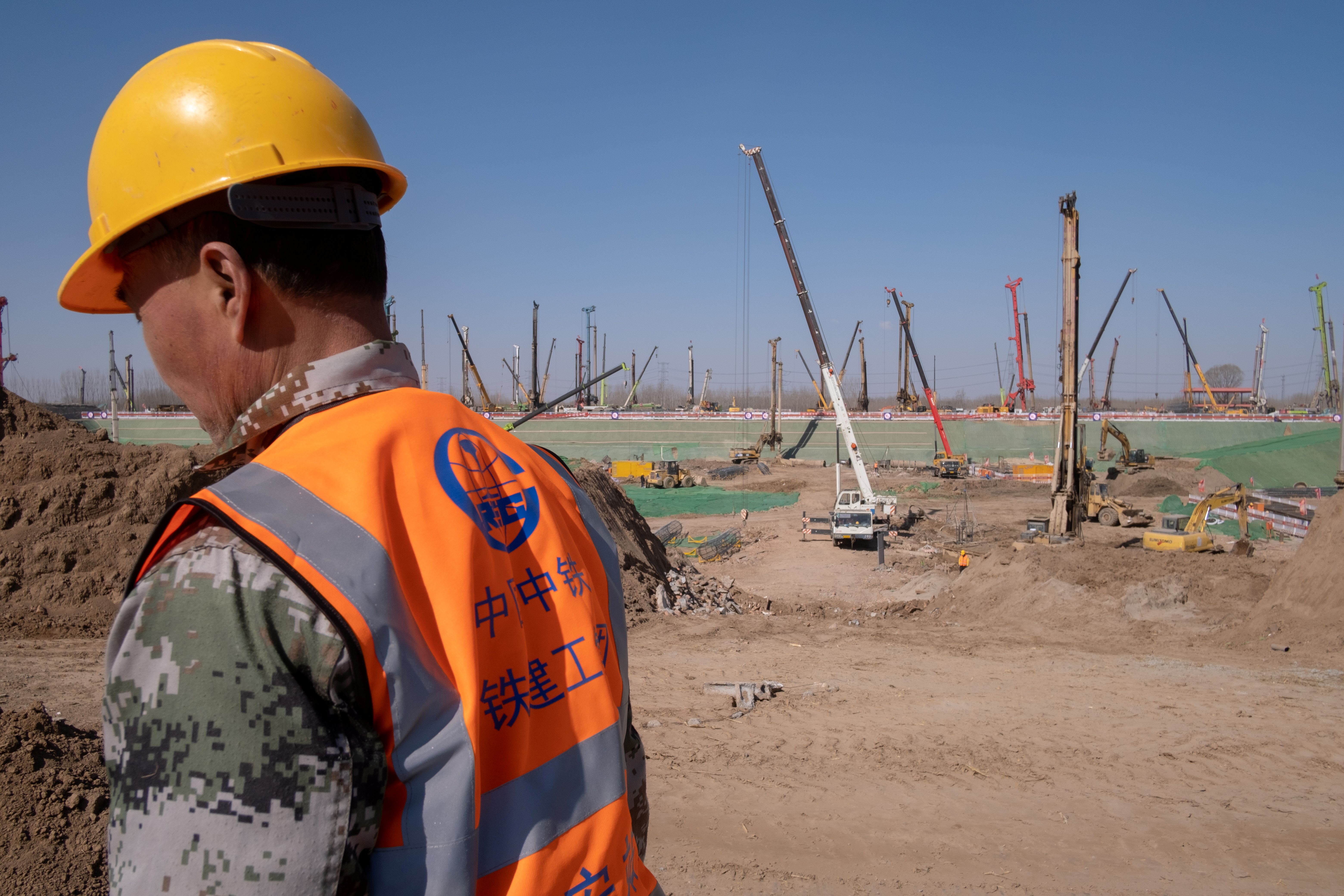 A worker of China Railway is seen at the construction site for the Xiongan station of the new railway connecting Beijing to Xiongan New Area, in Hebei province, China