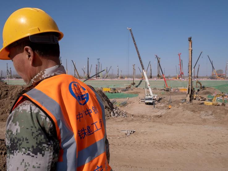 A worker of China Railway is seen at the construction site for the Xiongan station of the new railway connecting Beijing to Xiongan New Area, in Hebei province, China