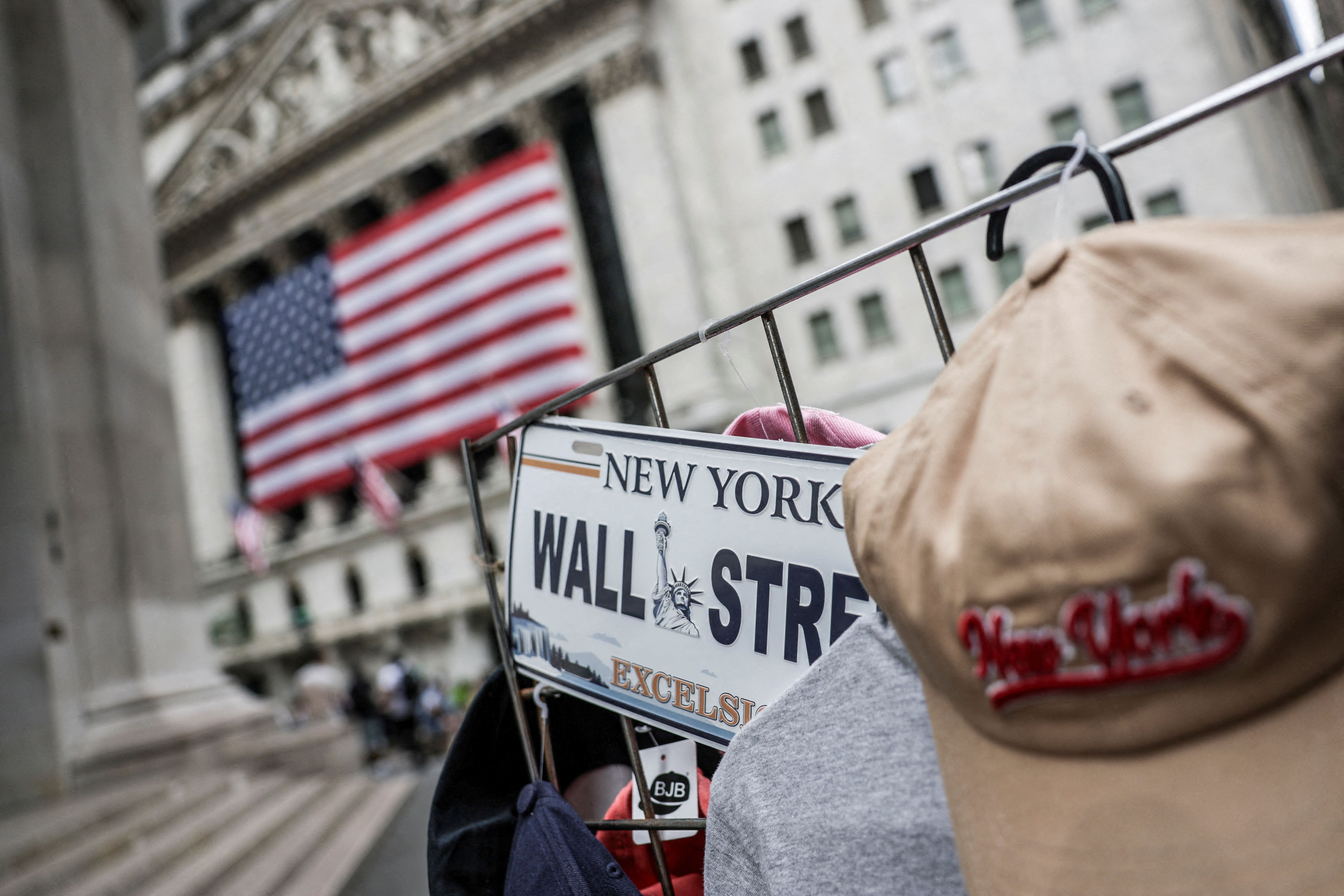 A Wall Street plate is seen on a street vendor stall outside the New York Stock Exchange.