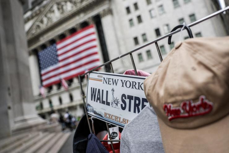A Wall Street plate is seen on a street vendor stall outside the New York Stock Exchange.