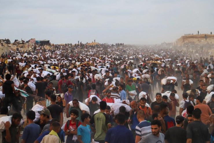 Palestinians carrying aid in Gaza