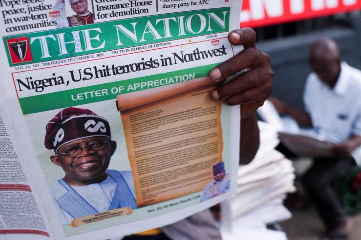 People read newspapers in Lagos.