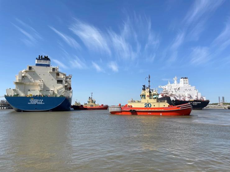 An LNG tanker is guided by tug boats at the Cheniere Sabine Pass LNG export unit in Louisiana.