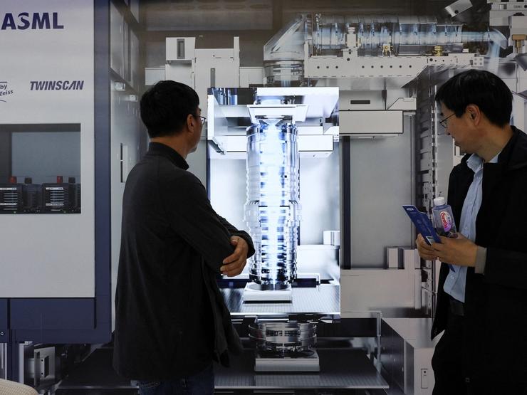 People visit the ASML booth during SEMICON China, a trade fair for semiconductor technology, in Shanghai.