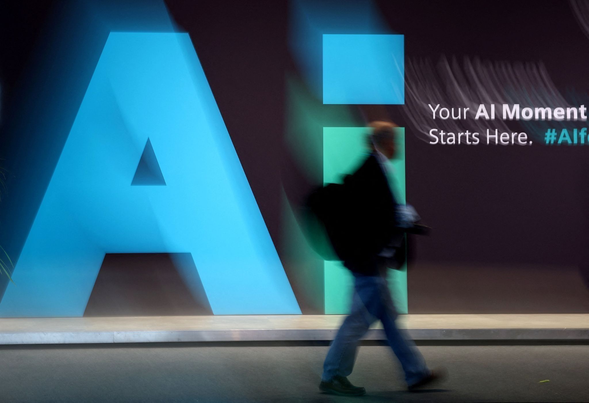 A man walks in front of an AI advertisement.