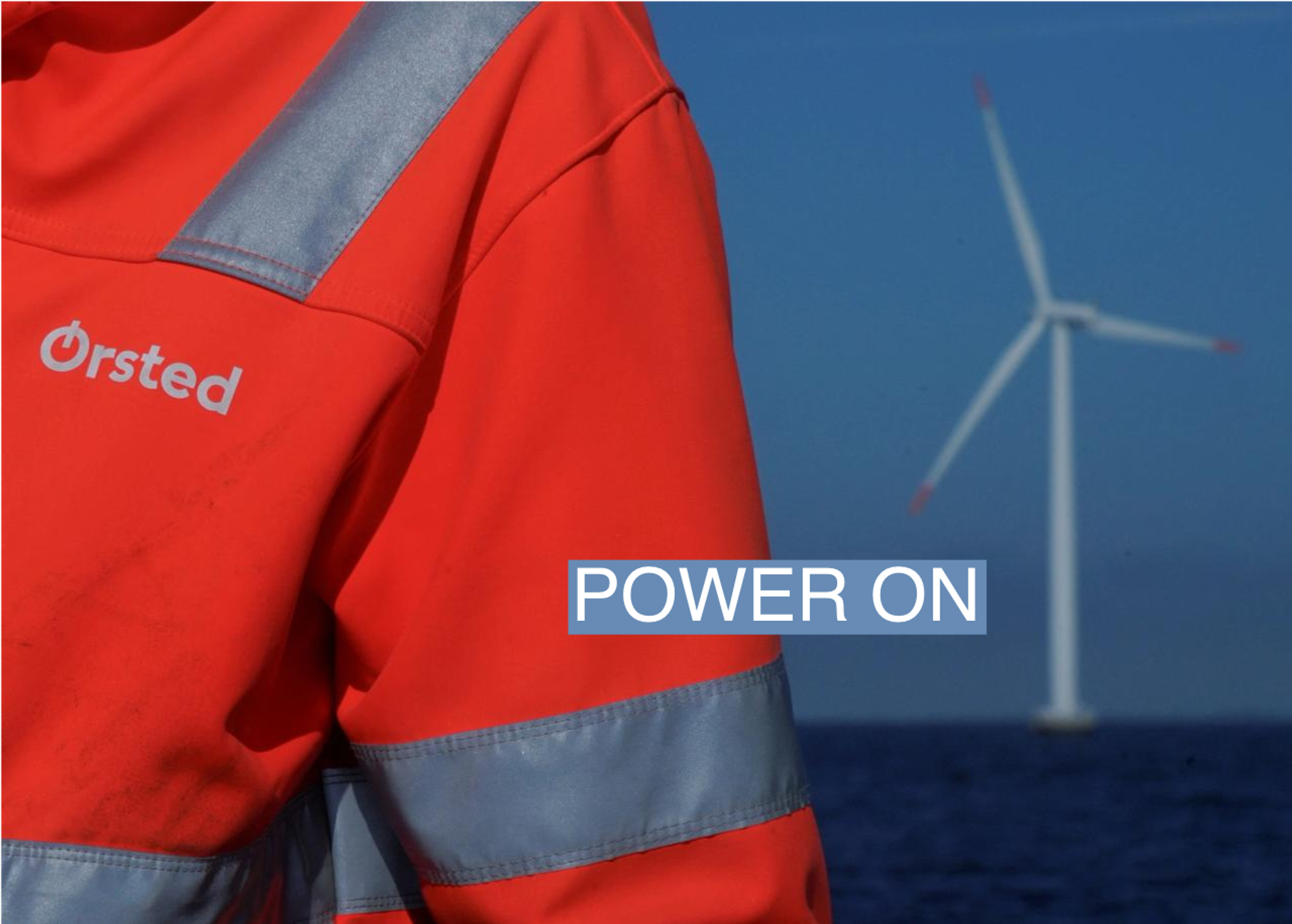 The logo for Orsted can be seen on the jacket worn by an employee as he talks to journalists during a visit to the offshore wind farm near Nysted, Denmark, September 4, 2023. REUTERS/Tom Little/File Photo